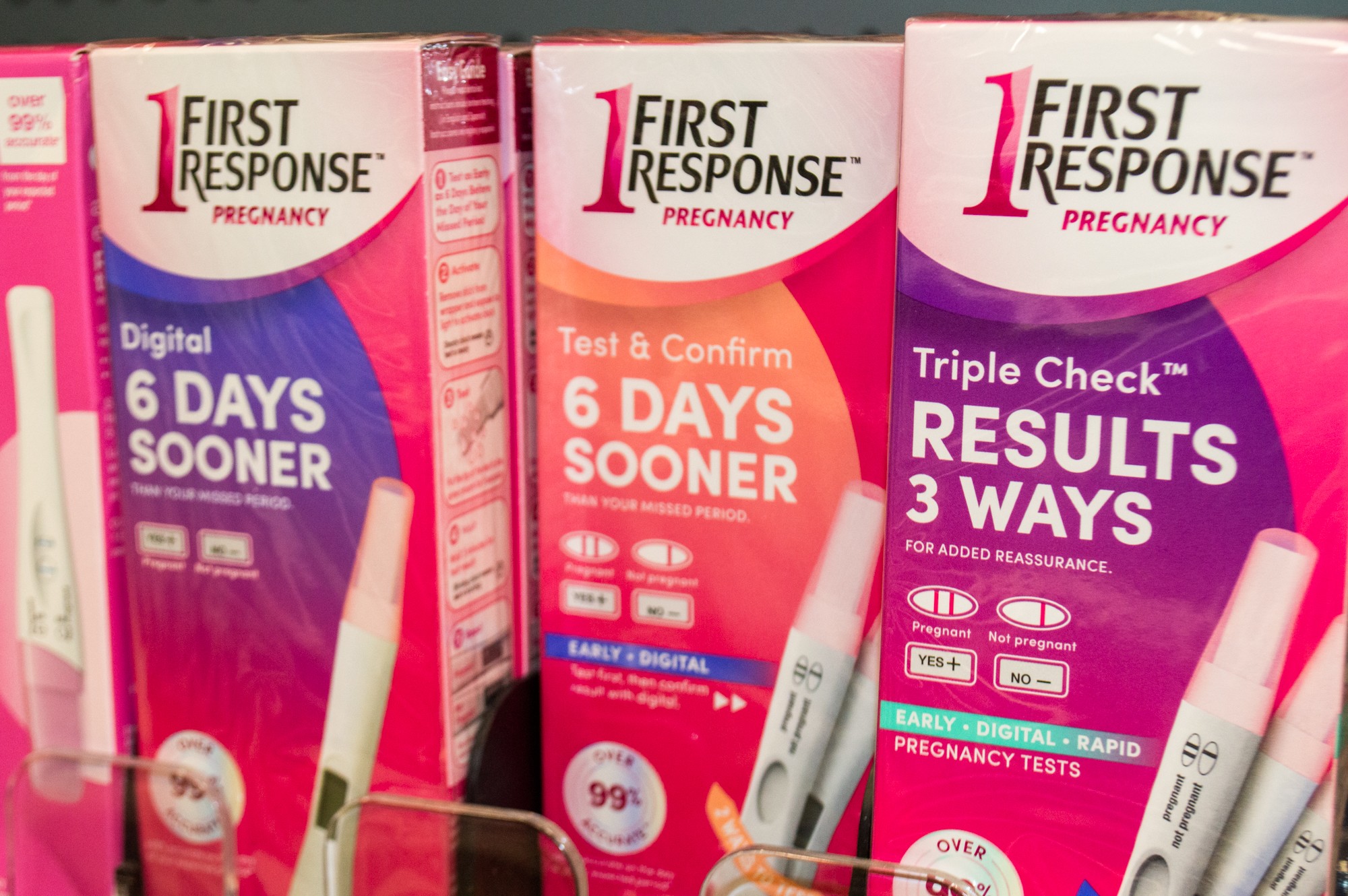 Photo of pink pregnancy tests on the shelf at a store.